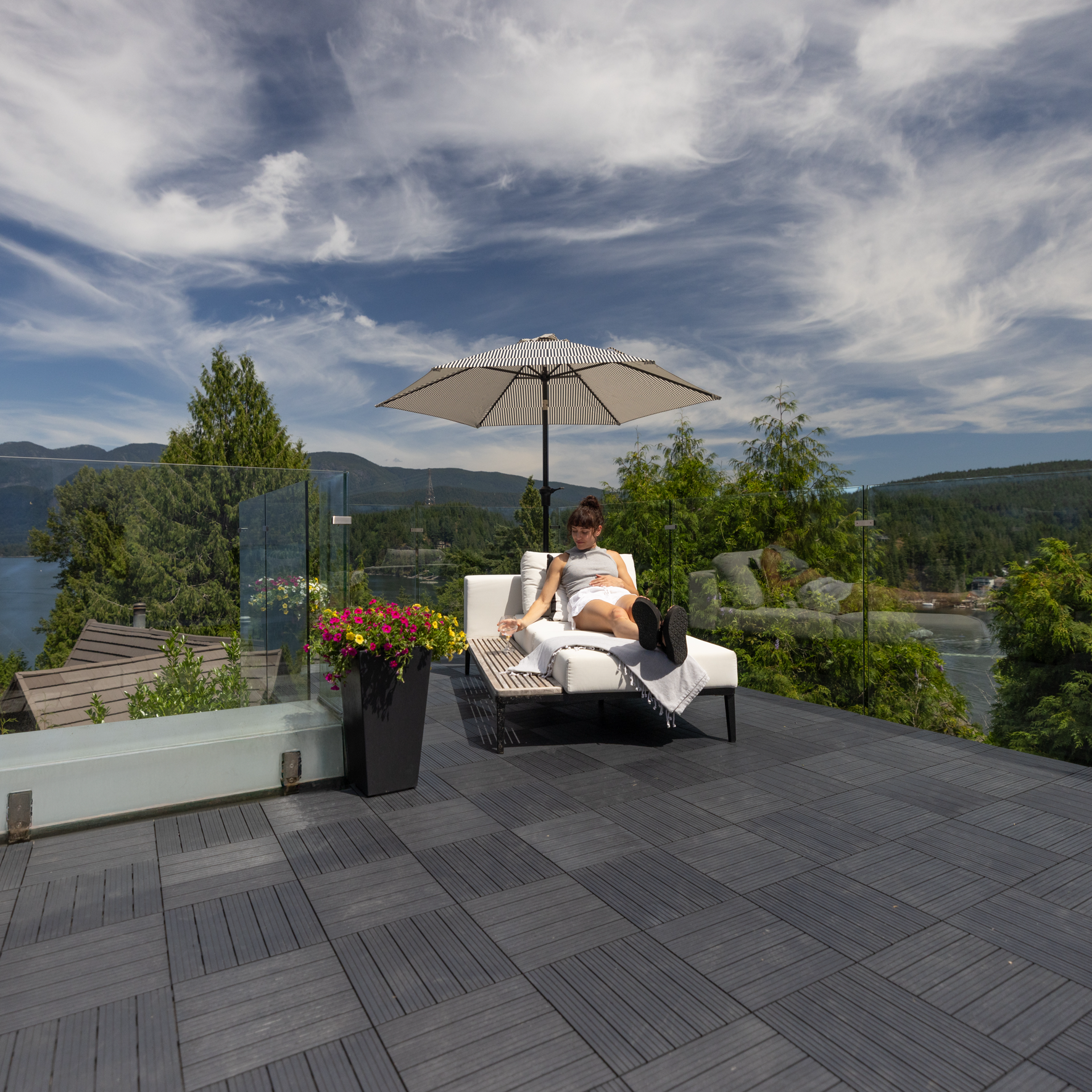 Person relaxing on patio with deck tiles