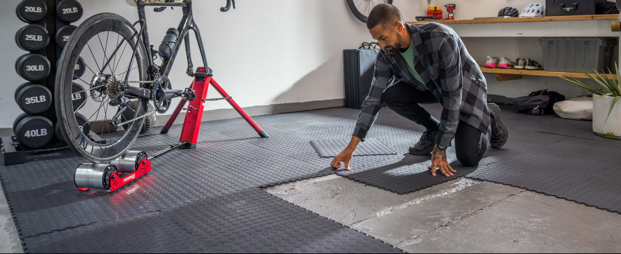 person installing tool free interlocking tiles in a garage
